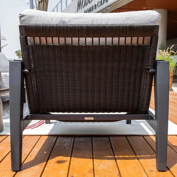 Back view of a lounge chair with a cushion on a wooden deck