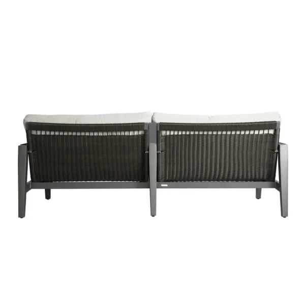 Back view of outdoor sofa with white cushions on a white background