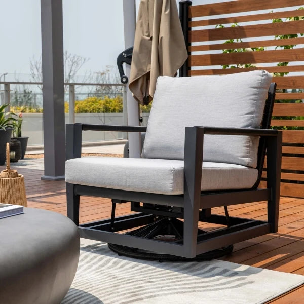 Outdoor swivel glider chair with gray cushions on a wooden deck