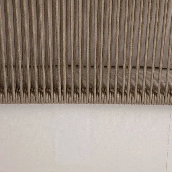 Close-up of a beige pleated fabric or slatted panel with vertical folds, shown against a plain white background.