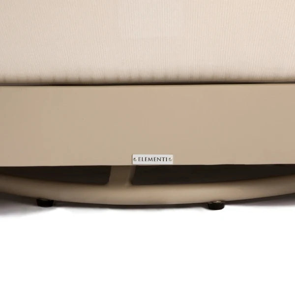 Close-up of the base of a beige upholstered chair or sofa, showing a small white label that reads 'ELEMENTi' and the dark feet at the bottom, set against a white background.