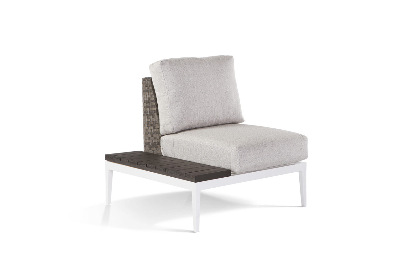 A modern outdoor lounge chair with a gray cushion and an accompanying left side table, both made of wicker and aluminum.