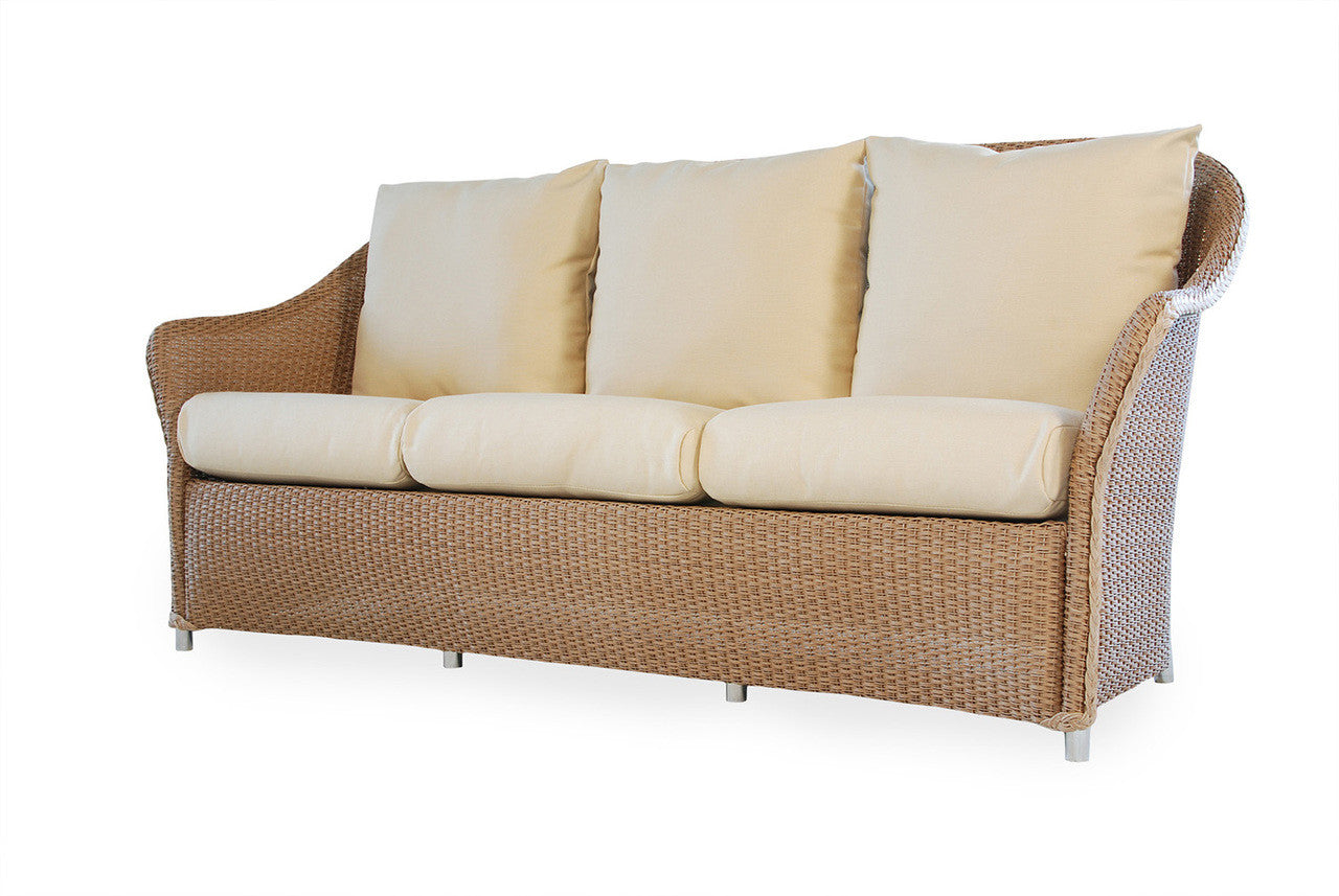 A wicker sofa with beige cushions and a white frame.