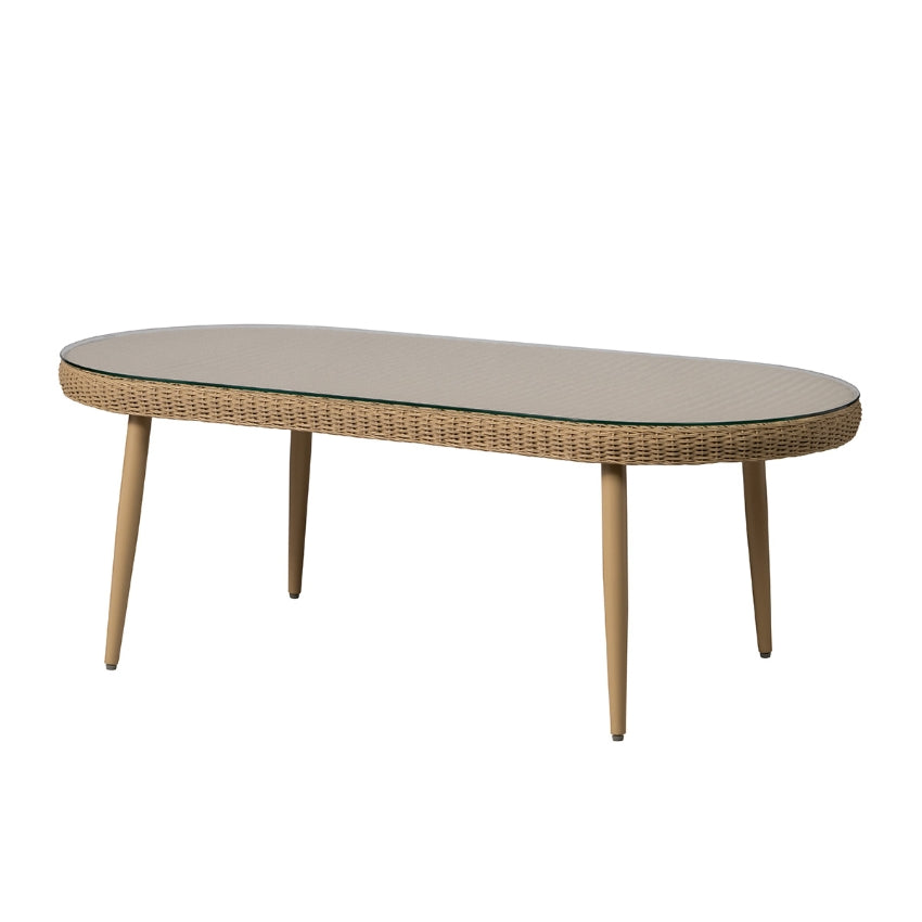 An oval cocktail table with a woven wicker frame, a light beige textured glass top, and four tapered wooden legs, shown against a plain white background.