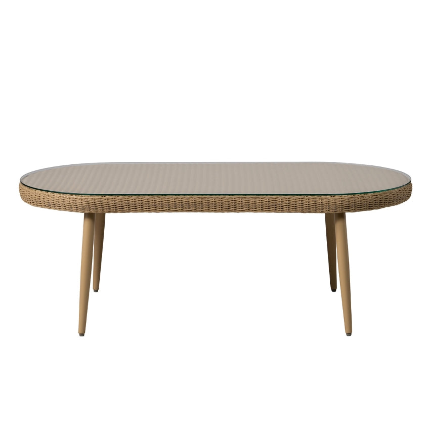 An oval outdoor cocktail table with a woven wicker frame, a clear glass top, and four tapered wooden legs, shown against a plain white background.