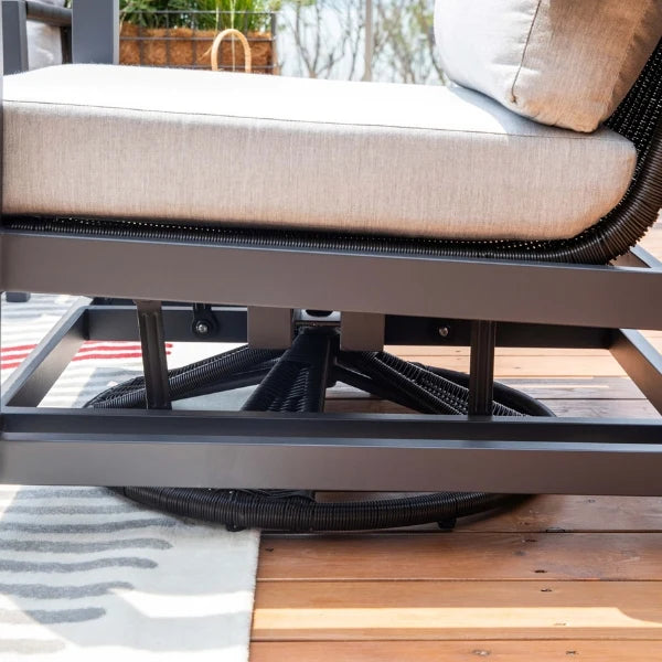 Close-up of a patio swivel glider chair with beige cushion on a wooden deck
