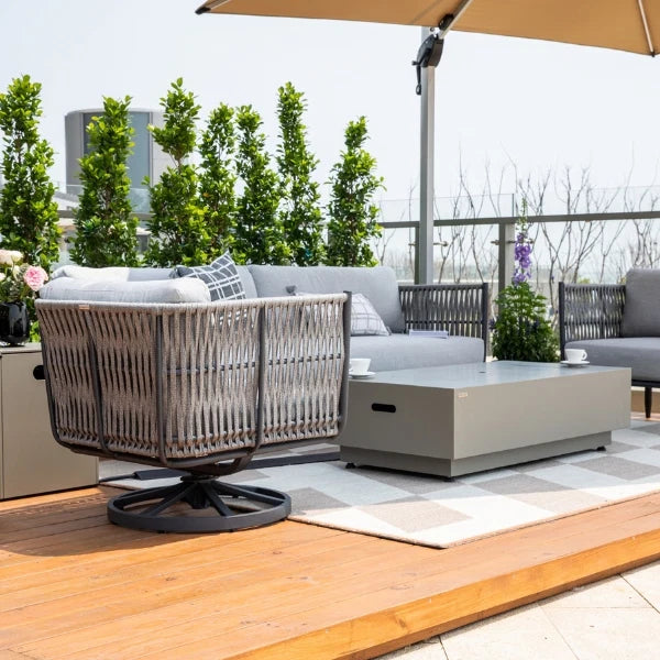 Outdoor patio set with furniture and umbrella on a wooden deck.