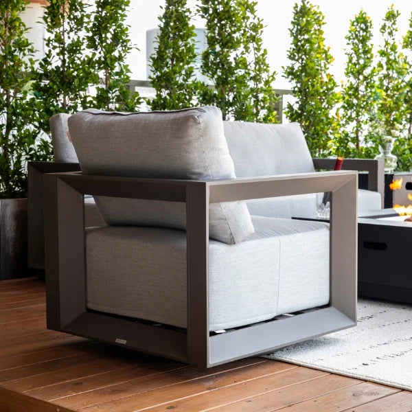 Modern outdoor swivel chair with cushions on a wooden deck